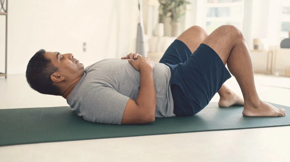 Pelvic tilt position: knees bent, back and hips flat on the mat