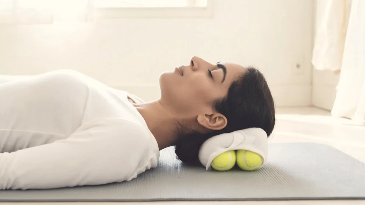 Two tennis balls in a sock cradling the base of the skull