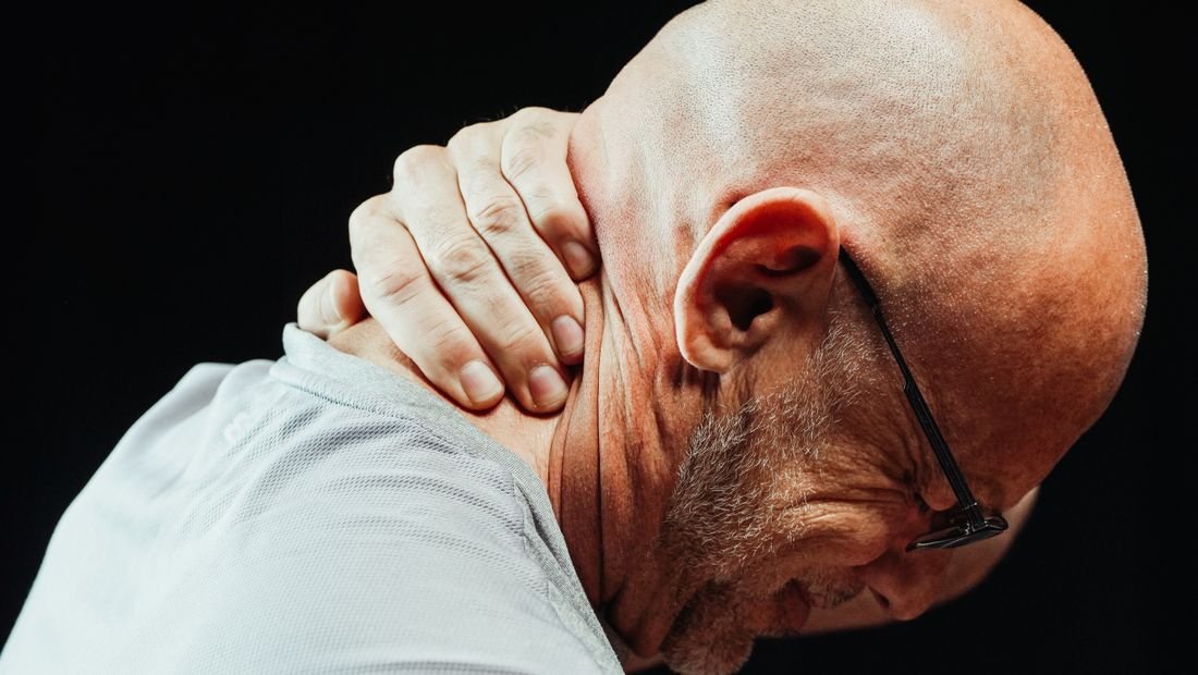 Man holding his neck in pain